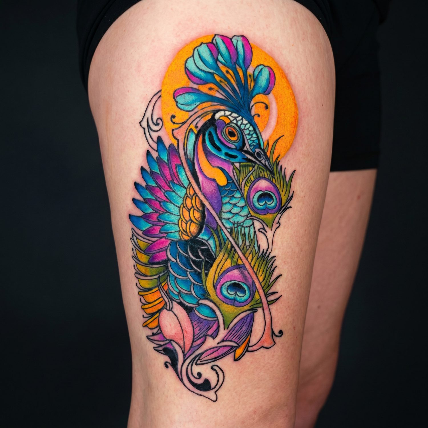 Vibrant color peacock and koi sleeve tattoo